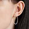 Closeup of earring on woman's ear