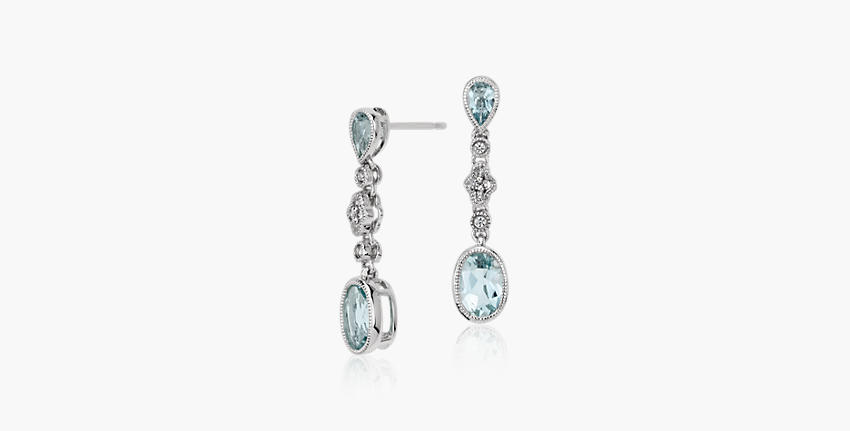Aquamarine gemstones featured in white diamond dangly earings