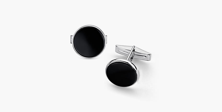 A pair of round inlaid black onyx cufflinks rimmed with sterling silver
