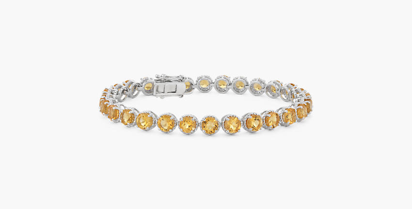 A November birthstone bracelet of twenty-eight round citrine gemstones rimmed in sterling silver miglrain halos