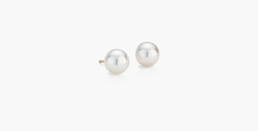 A pair of 8.5 millimeter light cream Akoya cultured pearl stud earrings with yellow gold posts