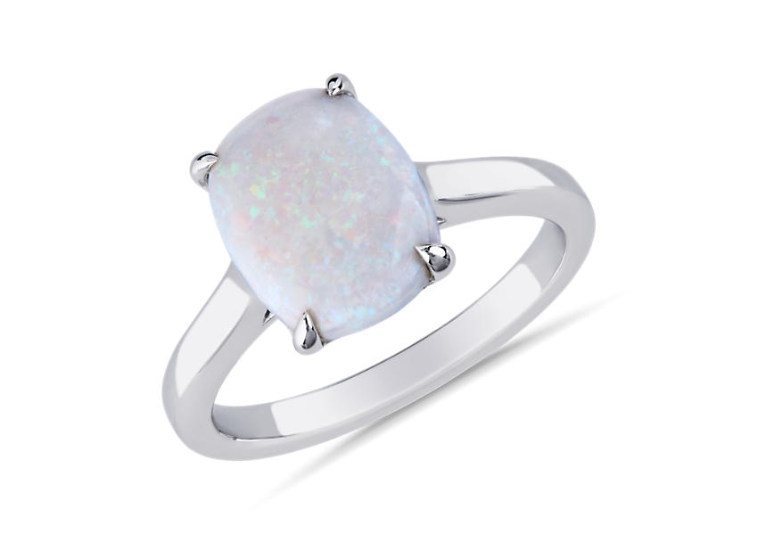 A white cabochon opal ring set in white gold engagement ring