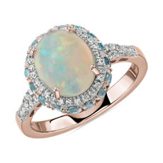 Bague opale ovale et halo de topazes bleu suisse en or rose 14 carats