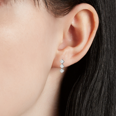 Closeup of earring on woman's ear