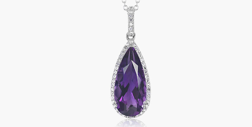 A February birthstone pendant of teardrop-shaped amethyst surrounded in a white topaz halo of twinkling hanging from a coordinating cable chain