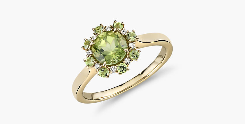 An August birthstone ring of peridot round-cut center gemstone surrounded by diamond and more peridot stones as floral petals and set in yellow gold