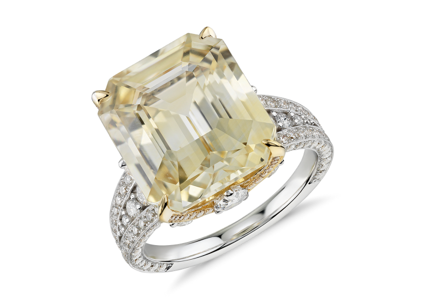 A yellow sapphire gemstone engagement ring showcasing 12 carat emerald-cut centre accented with pavé-set diamond in white and yellow gold
