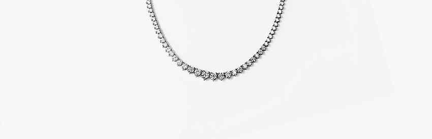Eternity graduated diamond necklace in 18k white gold.