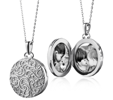 Silver locket with ornamental detail.