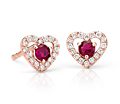 Earrings with two red rubies surrounded by an open heart of pavé diamonds set in 14k rose gold.