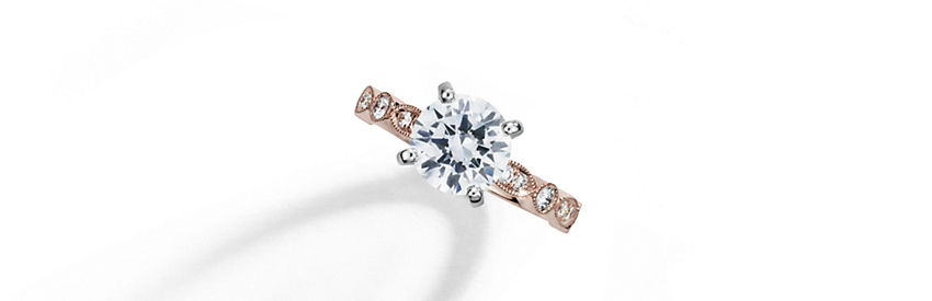 Milgrain marquise and dot pattern diamond engagement ring set with a round center diamond in 14k rose gold.