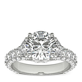 Triple row diamond Bella Vaughan engagement ring, featuring a round center diamond flanked by two trapezoid side stones.