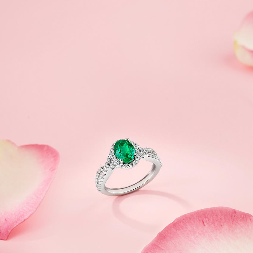 A emerald and diamond engagement ring