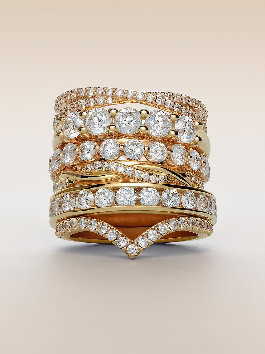 A stack of yellow gold diamond wedding rings.