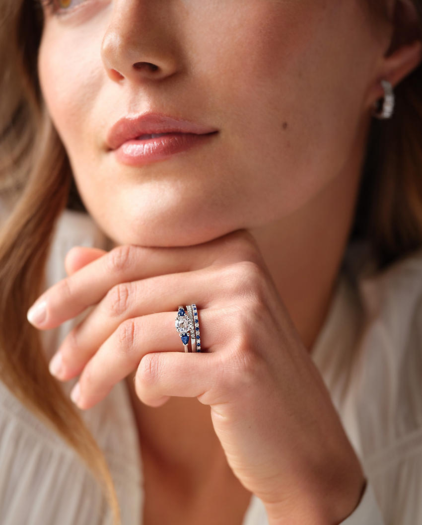 A woman wearing a gemstone engagement ring