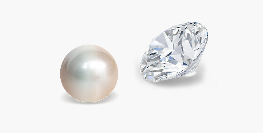 A loose freshwater pearl faces to the left across from a loose diamond gemstone facing to the right