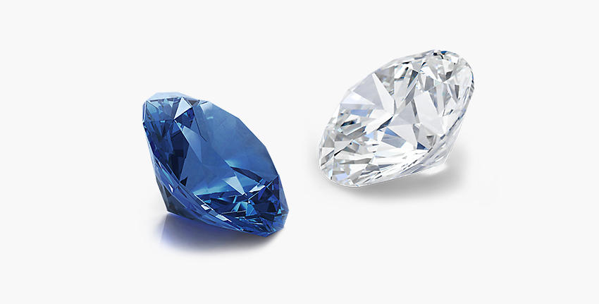 A loose sapphire gemstone faces to the left across from a loose diamond gemstone facing to the right
